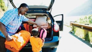 Father And Son Loading Car